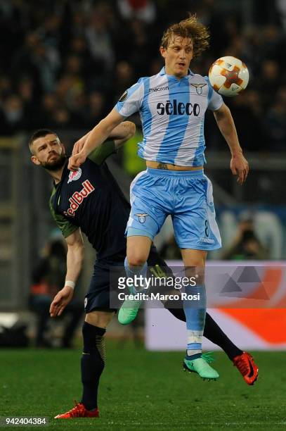 Dusan Basta of SS Lazio compete for the ball with Valon Berisha of Salzburg RB during the UEFA Europa League quarter final leg one match between...