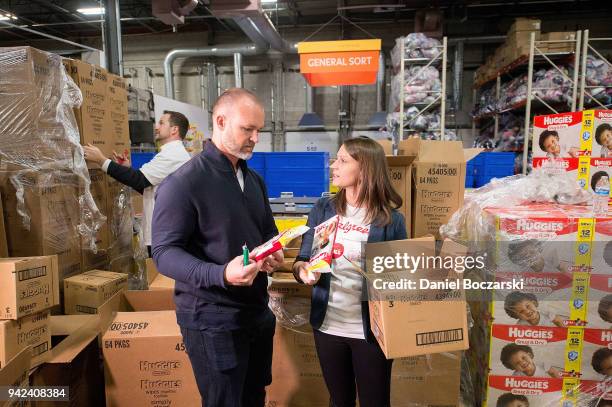 Former Chicago Cubs catcher and 2016 World Series Champion Davis Ross lends a hand with Kristine Rhode of Huggies at a diaper donation event hosted...