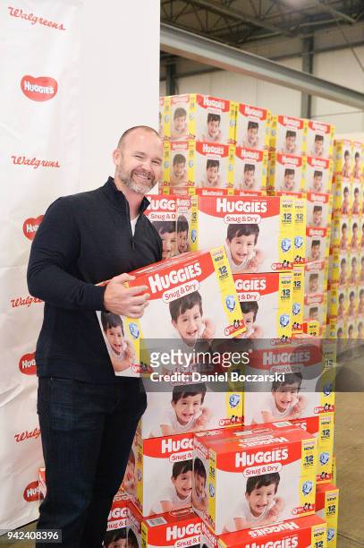 Former Chicago Cubs catcher and 2016 World Series Champion David Ross lends a hand at a diaper donation event hosted by Walgreens and Huggies at...