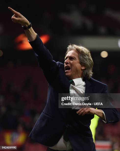 Jorge Jesus, manager of Sporting CP points towards his team's fans after the UEFA Europa League quarter final leg one match between Atletico Madrid...