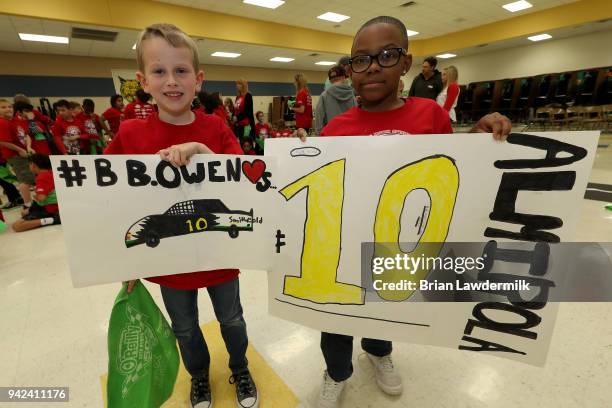 Students hold signs for Aric Almirola during a suprise presentation for the Lionel Racing "Design A Die-Cast" contest at B.B. Owen Elementary School...