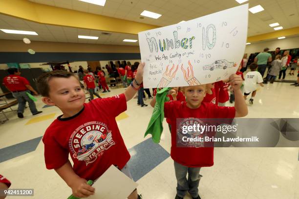 Students hold signs for Aric Almirola during a suprise presentation for the Lionel Racing "Design A Die-Cast" contest at B.B. Owen Elementary School...