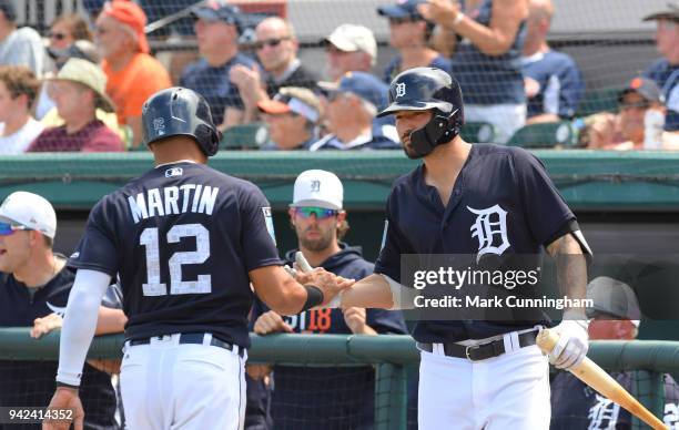 Leonys Martin and Nicholas Castellanos of the Detroit Tigers shake hands during the Spring Training game against the Atlanta Braves at Publix Field...