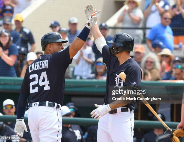 Miguel Cabrera and Nicholas Castellanos of the Detroit Tigers high-five during the Spring Training game against the Atlanta Braves at Publix Field at...