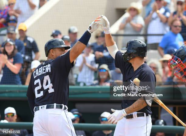 Miguel Cabrera and Nicholas Castellanos of the Detroit Tigers high-five during the Spring Training game against the Atlanta Braves at Publix Field at...