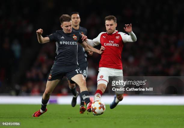 Aleksandr Golovin of CSKA Moscow tackles Aaron Ramsey of Arsenal during the UEFA Europa League quarter final leg one match between Arsenal FC and...