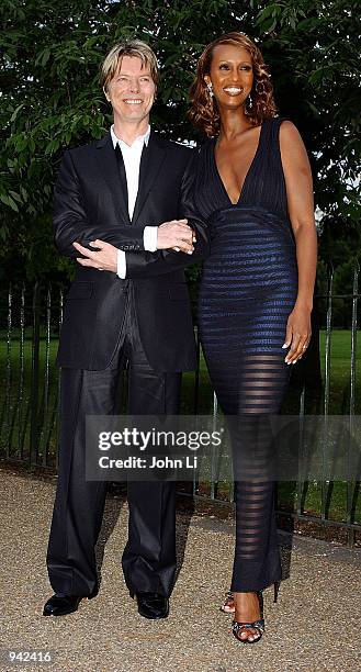 Singer David Bowie and his wife Iman attend the Serpentine Gallery Summer Party at the Serpentine Gallery in Kensington Gardens July 9, 2002 in...