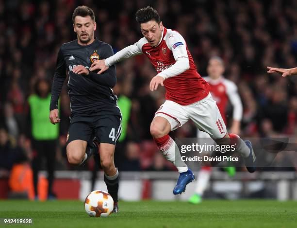 Mesut Ozil of Arsenal takes on Georgi Schennikov of CSKA during the UEFA Europa League quarter final leg one match between Arsenal FC and CSKA Moskva...