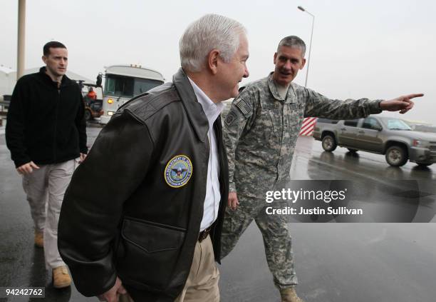 Secretary of Defense Robert Gates walks with U.S. Army Lt. General David Rodriguez before boarding a plane at Kabul International Airport December...