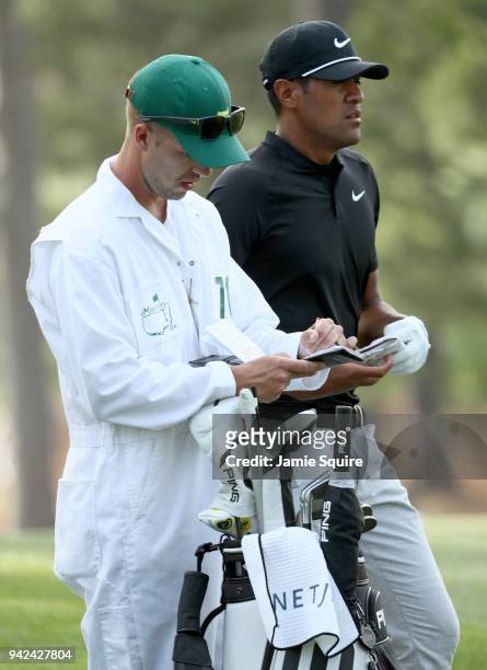 Tony Finau of the United States waits with caddie Gregory Bodine before hitting a shot on the 17th hole during the first round of the 2018 Masters...