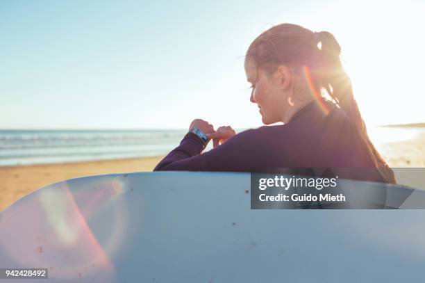 woman checking smartwatch. - longeville sur mer stock pictures, royalty-free photos & images