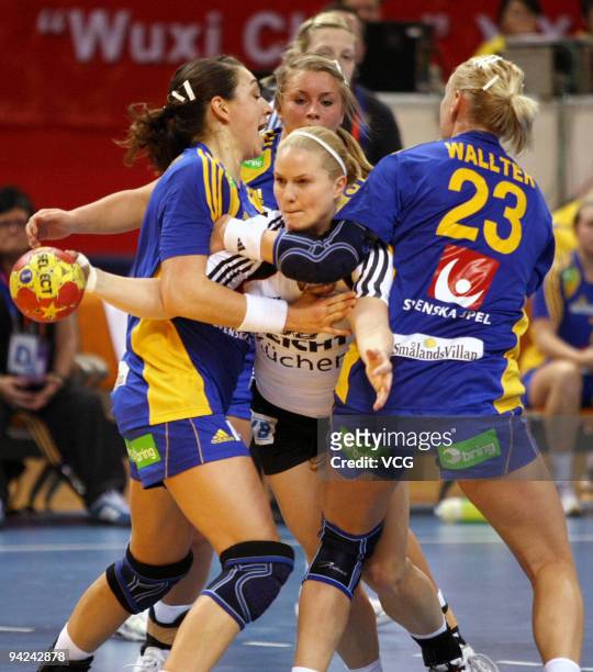 Anna Loerper of Germany is blocked by Sweden's Therese Wallter during the preliminary round match between Germany and Sweden at Wuxi Stadium on day...