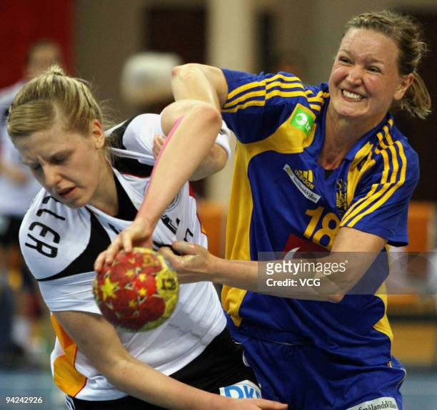 Susann Muller of Germany is blocked by Johanna Wiberg of Sweden during the preliminary round match between Germany and Sweden at Wuxi Stadium on day...