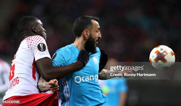 Ibrahima Konate of RB Leipzig vies with Kostas Mitroglou of Olympique Marseille during the UEFA Europa League quarter final leg one match between RB...