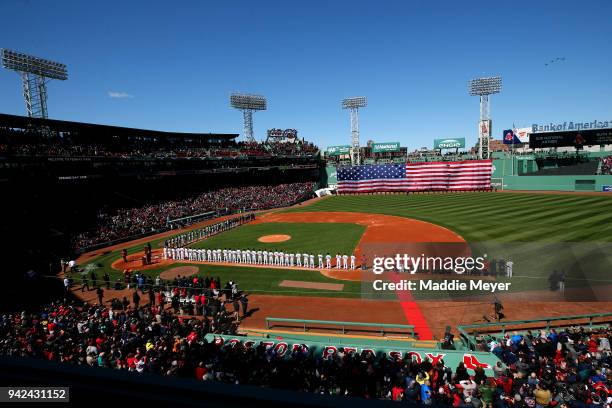 Members of the Boston Red Sox and the Tampa Bay Rays stand for the national anthem before the Red Sox home opening game at Fenway Park on April 5,...