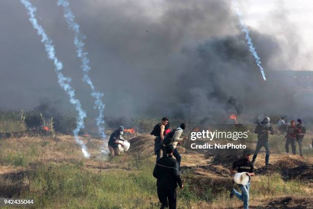 Palestinian protester takes part during clashes with Israeli troops near the border with Israel in the east of Gaza City on, 05 April 2018. One...