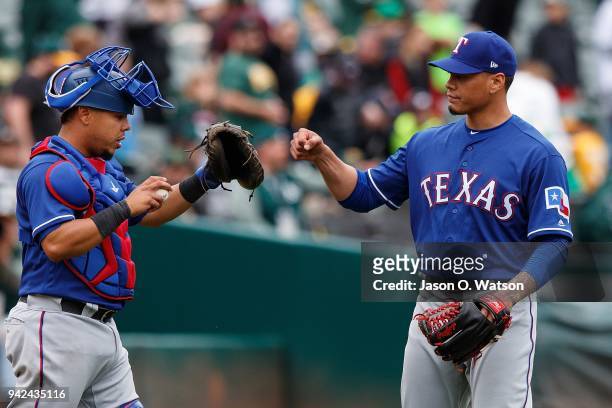 Keone Kela of the Texas Rangers celebrates with Juan Centeno after the game against the Oakland Athletics at the Oakland Coliseum on April 5, 2018 in...
