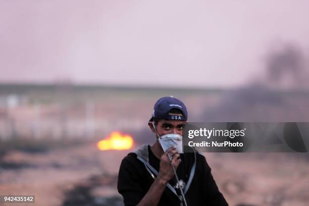 Palestinian protester takes part during clashes with Israeli troops near the border with Israel in the east of Gaza City on, 05 April 2018. One...