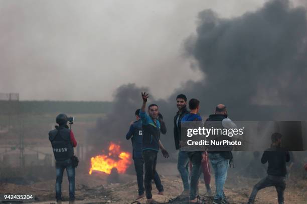 Palestinian protester takes part during clashes with Israeli troops near the border with Israel in the east of Gaza City on, 05 April 2018. One...