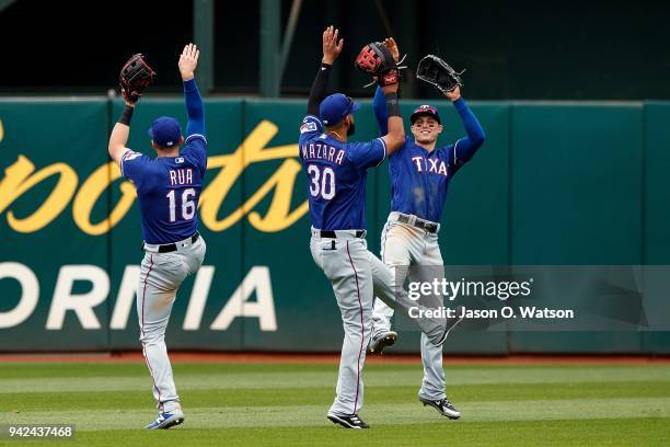 Ryan Rua of the Texas Rangers, Nomar Mazara; Drew Robinson celebrate after the game against the Oakland Athletics at the Oakland Coliseum on April 5,...