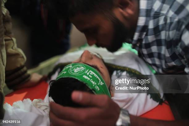 Palestinian protester takes part during clashes with Israeli troops near the border with Israel in the east of Gaza City on, 05 April 2018. One...