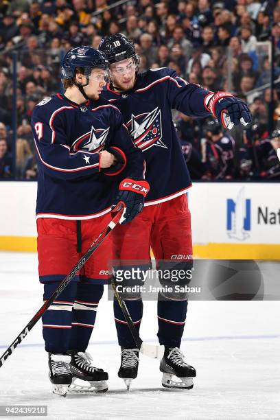 Pierre-Luc Dubois of the Columbus Blue Jackets talks with teammate Artemi Panarin of the Columbus Blue Jackets prior to a face-off during the first...