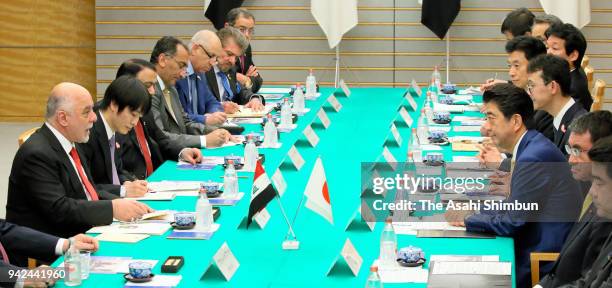 Iraqi Prime Minister Haider al-Abadi and Japanese Prime Minister Shinzo Abe talk during their meeting at the prime minister's official residence on...