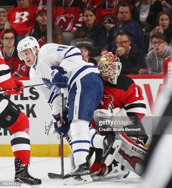 Zach Hyman of the Toronto Maple Leafs bumps into Keith Kinkaid of the New Jersey Devils during the first period at the Prudential Center on April 5,...