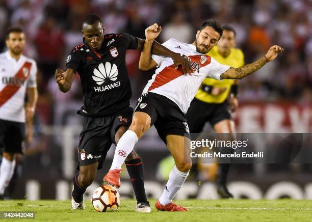 Ignacio Scocco of River Plate fights for ball with Baldomero Perlaza of Independiente Santa Fe during a Copa CONMEBOL Libertadores match between...