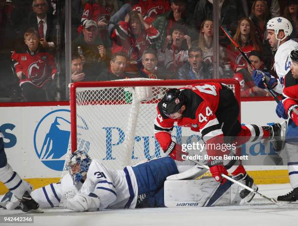 Frederik Andersen of the Toronto Maple Leafs makes the first period save as Miles Wood of the New Jersey Devils looks for the rebound at the...