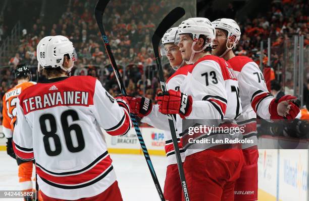 Sebastian Aho of the Carolina Hurricanes celebrates his first period goal against the Philadelphia Flyers with teamamtes Teuvo Teravainen, Valentin...