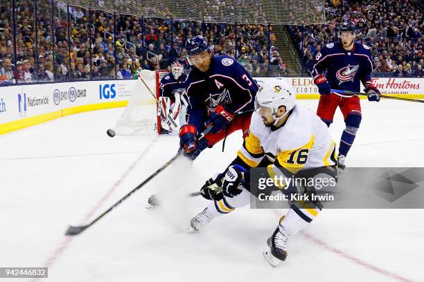 Josh Jooris of the Pittsburgh Penguins flips the puck past Seth Jones of the Columbus Blue Jackets during the first period on April 5, 2018 at...