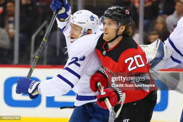 New Jersey Devils center Blake Coleman battles Toronto Maple Leafs defenseman Nikita Zaitsev during the first period of the National Hockey League...