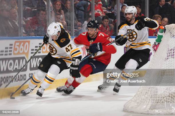 Torey Krug and Adam McQuaid of the Boston Bruins defend against Colton Sceviour of the Florida Panthers at the BB&T Center on April 5, 2018 in...