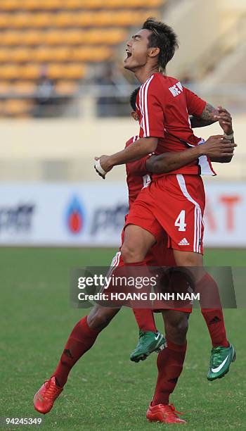 Myanmar's Moe Win celebrates with teammate Khin Maung Lwin after he scored the team's third goal during their preliminary football match against...