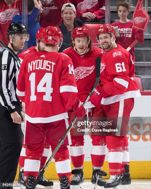 Tyler Bertuzzi of the Detroit Red Wings celebrates his second period goal with teammates Gustav Nyquist, Henrik Zetterberg and Xavier Ouellet during...