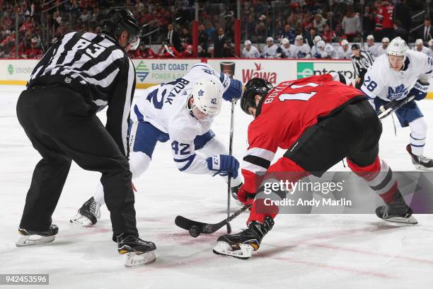 Brian Boyle of the New Jersey Devils faces off against Tyler Bozak of the Toronto Maple Leafs during the game at Prudential Center on April 5, 2018...