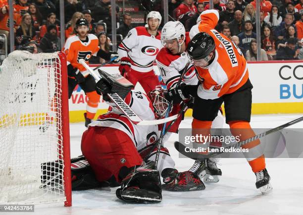 Ivan Provorov of the Philadelphia Flyers battles in front of goaltender Scott Darling of the Carolina Hurricanes with Lee Stempniak on April 5, 2018...