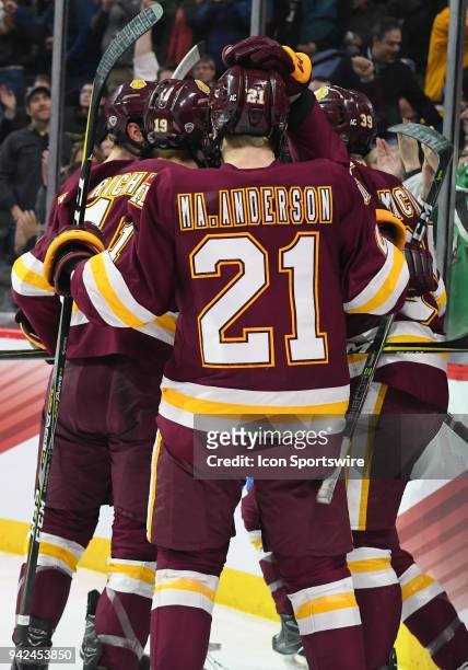 Minnesota-Duluth Bulldogs defenseman Louie Roehl is congratulated by teammates after scoring a 1st period goal during a Frozen Four Semifinal between...