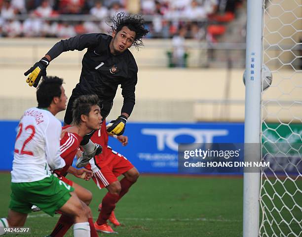 Indonesia's goalkeeper Frenky Irawan fails to save a header by Myanmar's Moe Win during their preliminary football match at the 25th Southeast Asian...