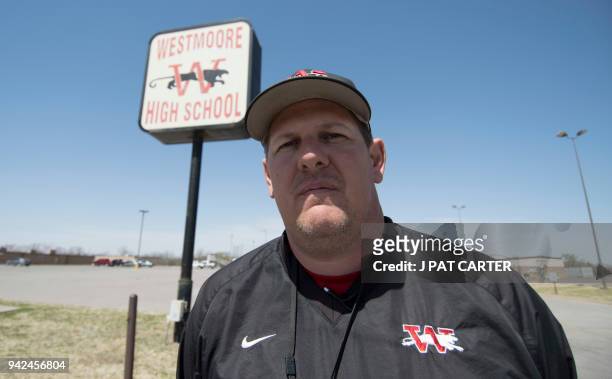 Scott Teel stands in front of his Moore, Oklahoma school sign on April 4, 2018. Buoyed by a nine-day strike in West Virginia which led to a five...