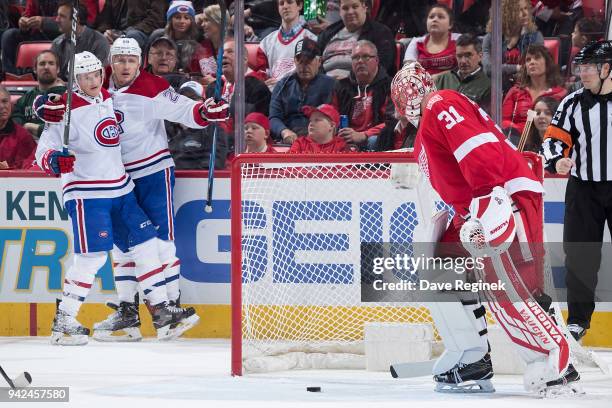 Nicolas Deslauriers of the Montreal Canadiens celebrates his second period goal with teammate Daniel Carr behind the net of Jared Coreau of the...