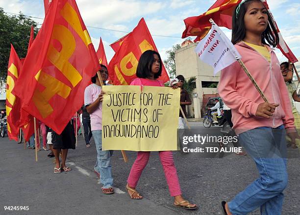 Residents march in the streets during a protest condemning the massacre of journalists in General Santos City, South Cotabato on November 30, 2009. A...