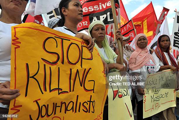 Muslim women display placards during a protest condemning the massacre of journalists in General Santos City, South Cotabato on November 30, 2009. A...