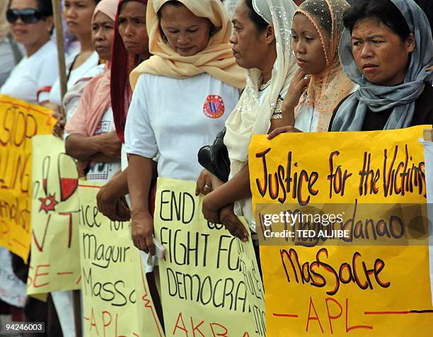 Muslim women display placards during a protest condemning the massacre of journalists in General Santos City, South Cotabato on November 30, 2009. A...