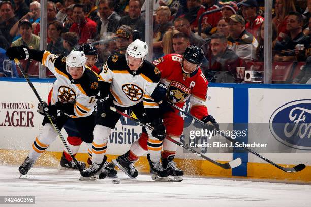 Ryan Donato of the Boston Bruins and teammate Colby Cave skate for possession against Aleksander Barkov of the Florida Panthers at the BB&T Center on...