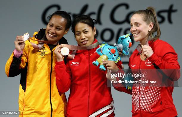 Silver medalist Loa Dika Toua of Papua New Guinea, gold medalist Sanjita Chanu Khumukcham of India and bronze medalist Rachel Leblanc-Bazinet of...