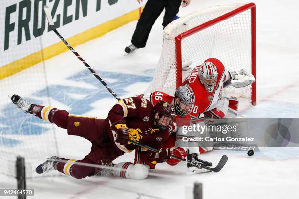 Matt Joyaux and Sean Romeo of the Ohio State Buckeyes defend the goal against Riley Tufte of the Minnesota-Duluth Bulldogs during the Division I...