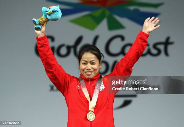 Gold medalist Sanjita Chanu Khumukcham of India celebrates during the medal ceremony for the Women's 53kg weightlifting final on day two of the Gold...