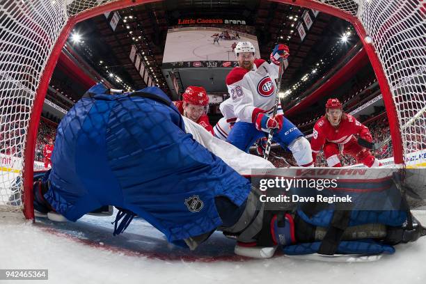 Goaltender Antti Niemi of the Montreal Canadiens makes a save as teammate Jeff Petry defends against Justin Abdelkader and Tyler Bertuzzi of the...